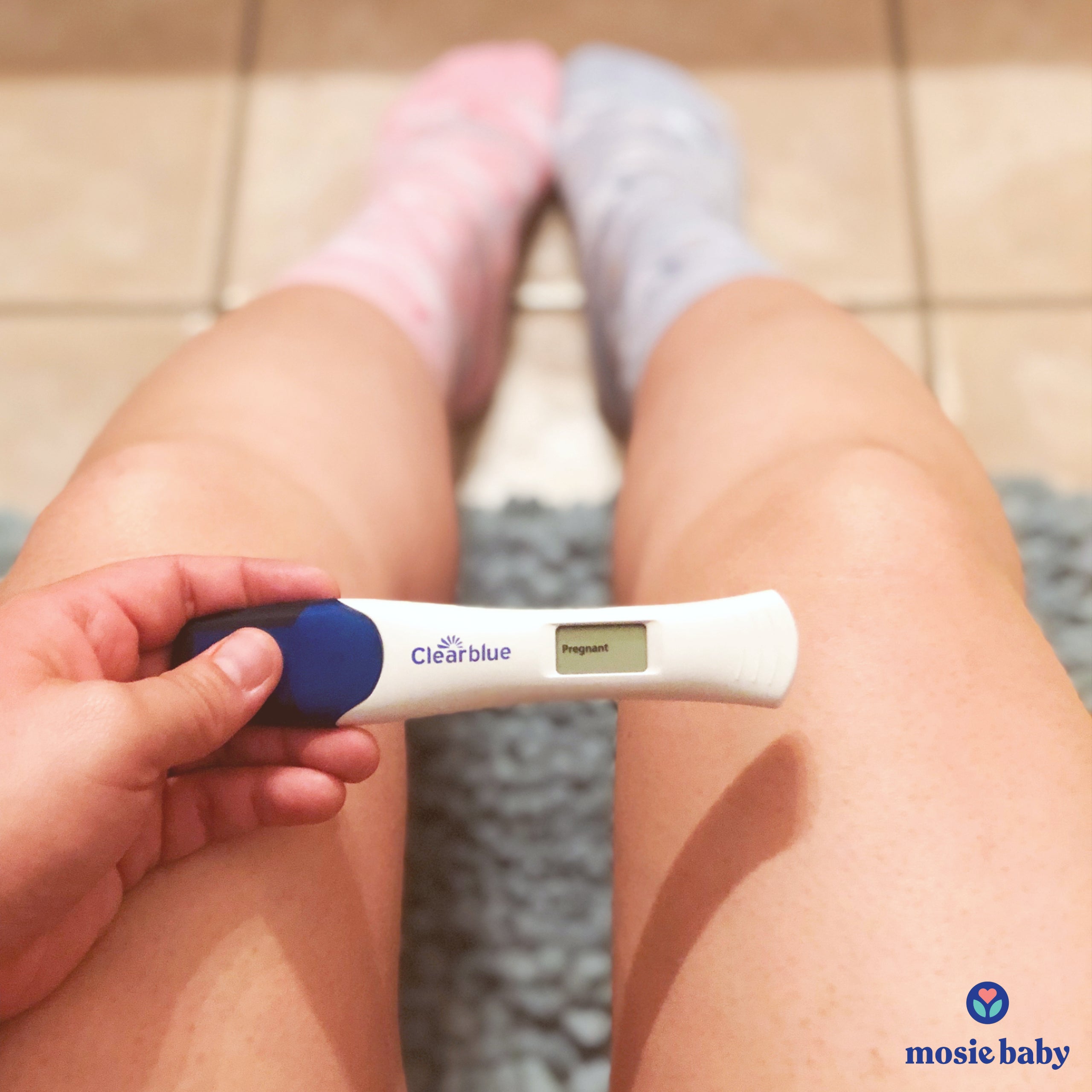 Woman holding a positive pregnancy test 