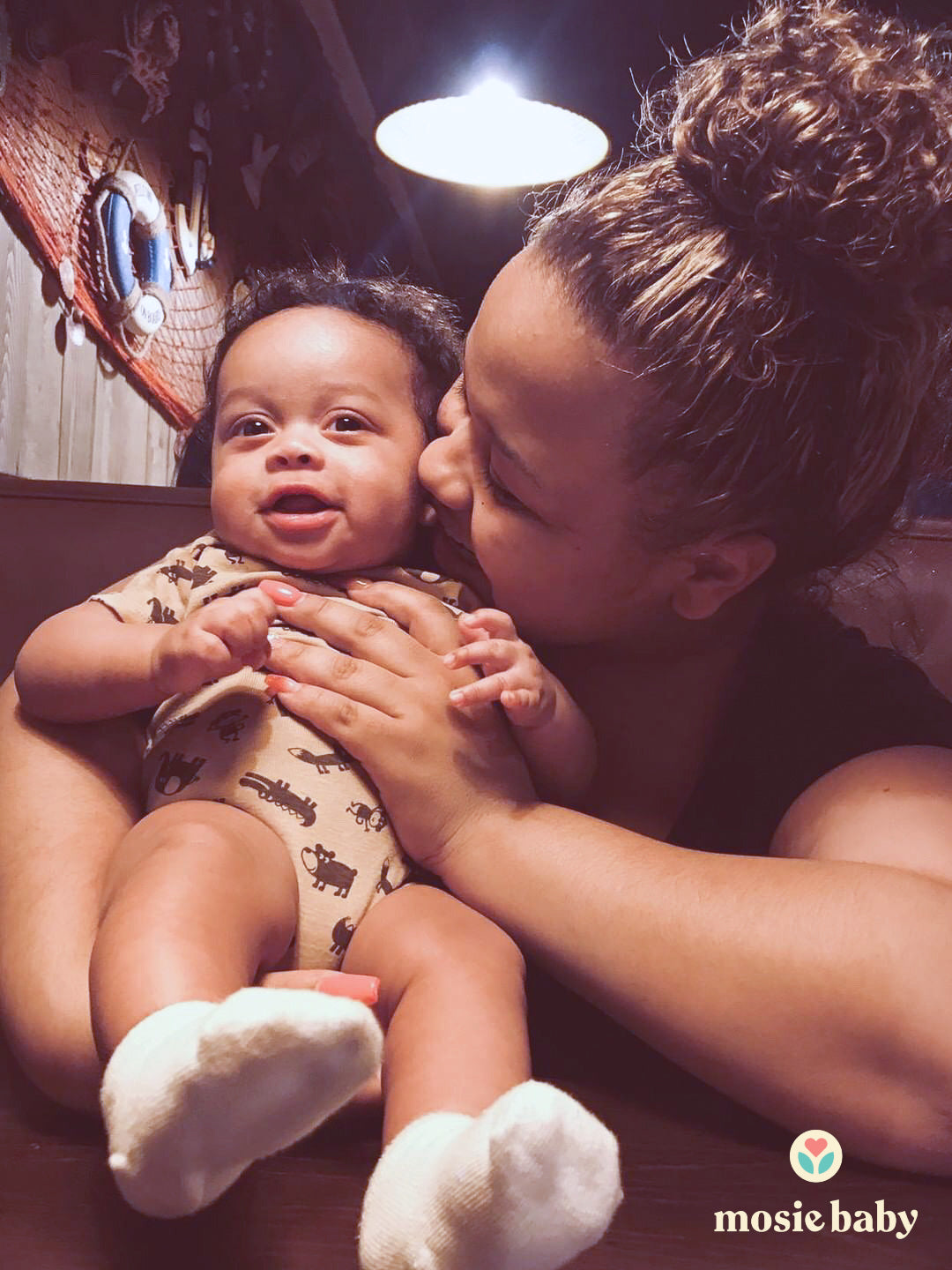 Mosie mom kissing her baby on the cheek