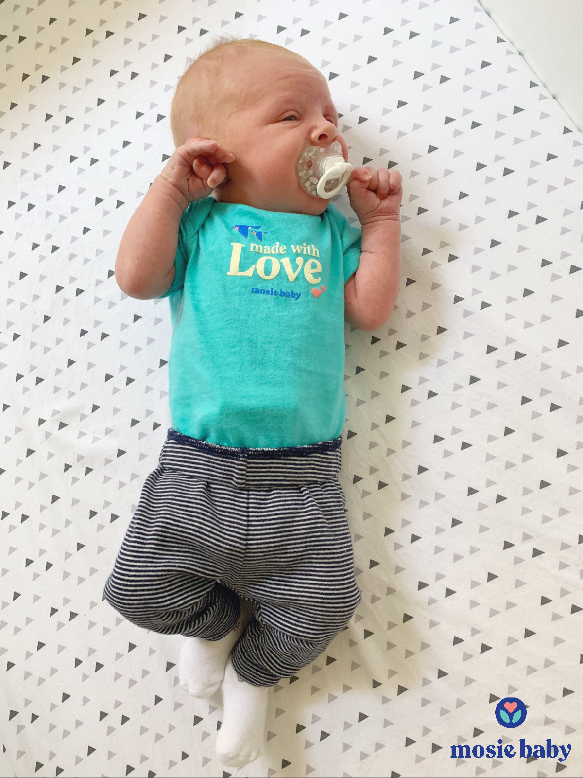 Newborn in a mosie baby onesie